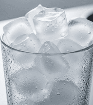 A glass filled with ice cubes,
